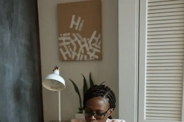 photo of woman working on white paper